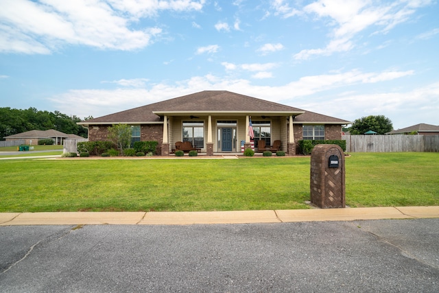 view of front of property featuring a front yard and covered porch