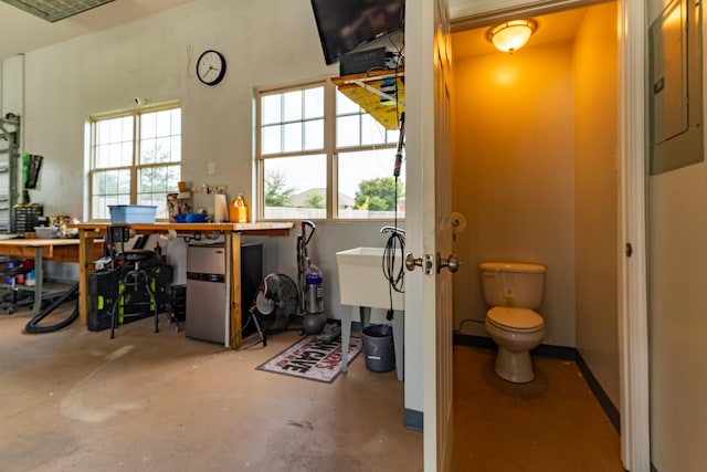 bathroom with toilet and concrete flooring