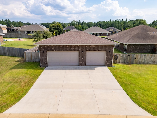 view of front of home featuring a front yard and a garage