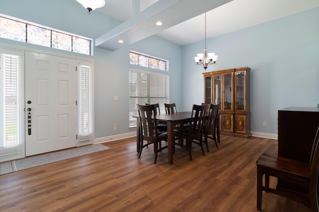 dining room with a notable chandelier, dark wood-type flooring, and plenty of natural light