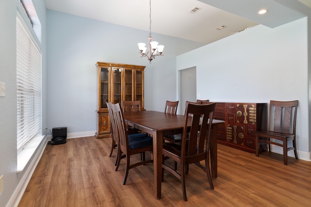 dining area featuring a chandelier and hardwood / wood-style flooring