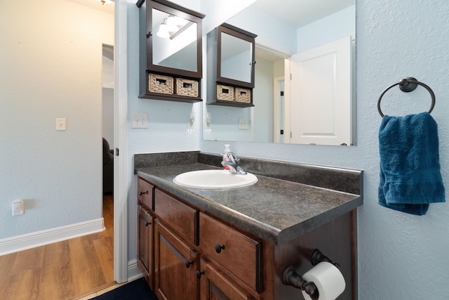 bathroom featuring wood-type flooring and vanity