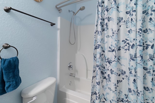 bathroom with toilet and shower / bathtub combination with curtain