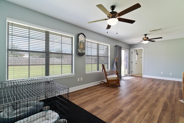 interior space featuring ceiling fan, hardwood / wood-style flooring, and plenty of natural light