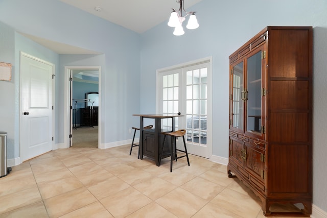 tiled dining area with a notable chandelier and french doors