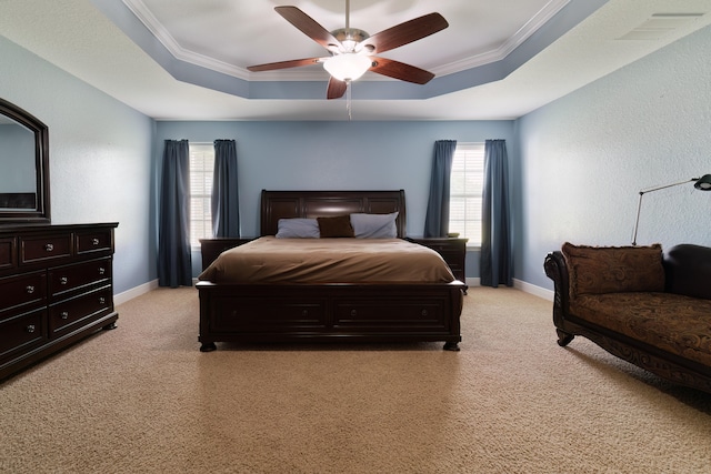 bedroom with a tray ceiling, ceiling fan, crown molding, and light carpet