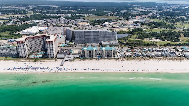 bird's eye view featuring a water view and a beach view