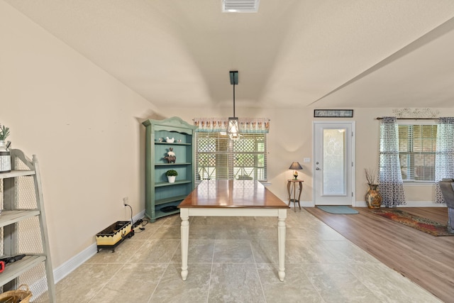 unfurnished dining area featuring light hardwood / wood-style floors and a notable chandelier