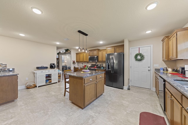 kitchen featuring a breakfast bar, light tile patterned flooring, a center island, appliances with stainless steel finishes, and hanging light fixtures