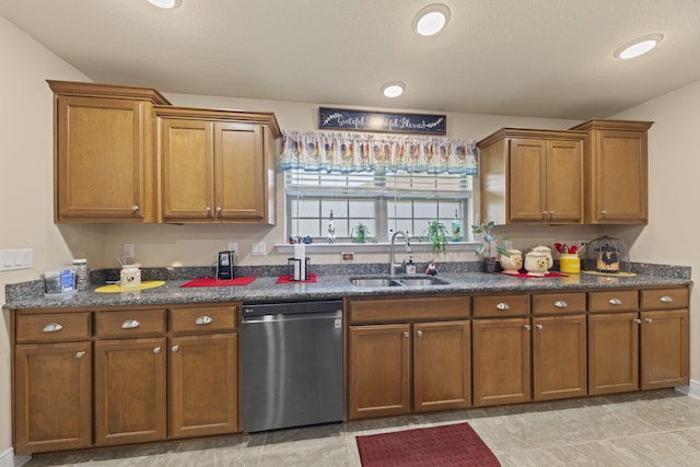 kitchen featuring sink, dishwasher, and light tile patterned floors