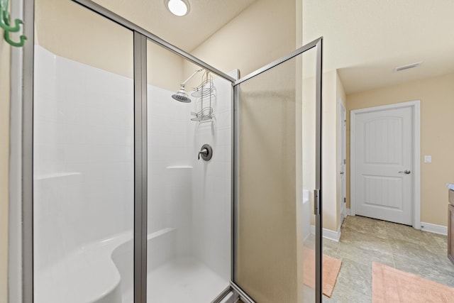 bathroom with tile patterned flooring and a shower with door