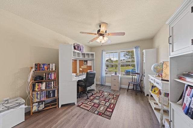 office with ceiling fan, a textured ceiling, and light hardwood / wood-style flooring