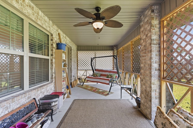 unfurnished sunroom featuring ceiling fan