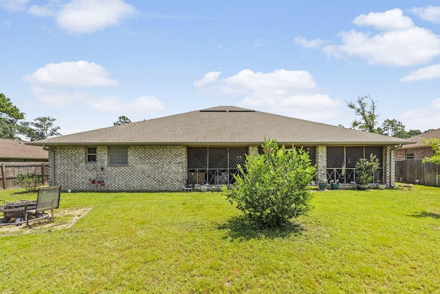 rear view of house featuring a yard