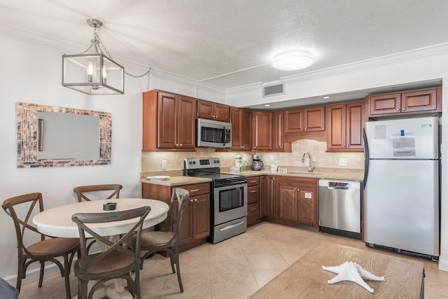 kitchen with sink, stainless steel appliances, tasteful backsplash, and an inviting chandelier