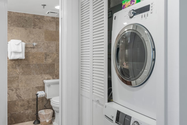 laundry area with stacked washer and dryer