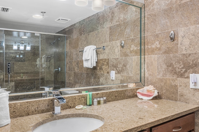 bathroom with an enclosed shower and vanity