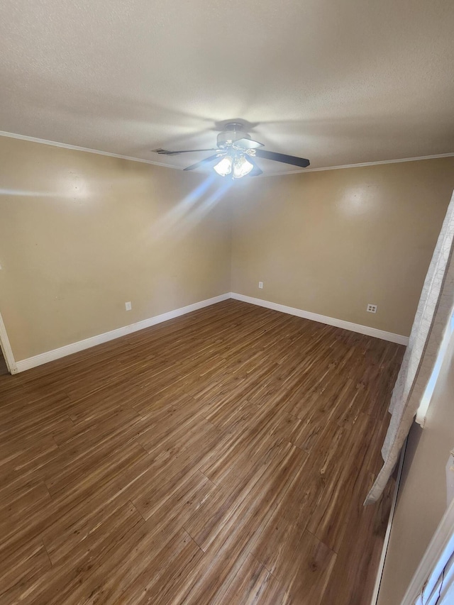 empty room featuring crown molding, dark hardwood / wood-style flooring, ceiling fan, and a textured ceiling