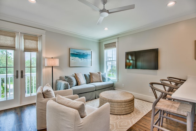 living room featuring dark hardwood / wood-style floors, ceiling fan, and ornamental molding