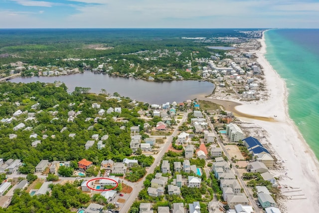 birds eye view of property with a water view and a view of the beach