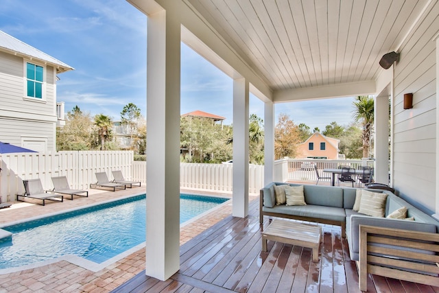 exterior space featuring an outdoor hangout area, a patio area, and a fenced in pool