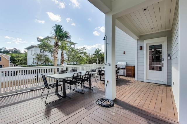 wooden terrace with a grill