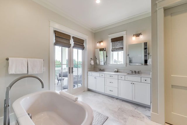 bathroom with a washtub, french doors, crown molding, and vanity