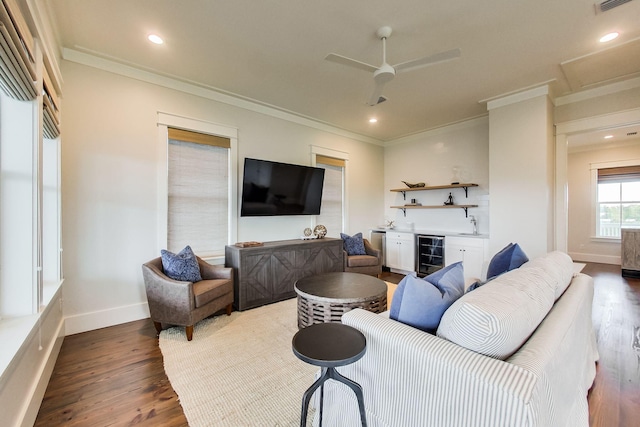 living room featuring wine cooler, bar, ceiling fan, hardwood / wood-style floors, and crown molding