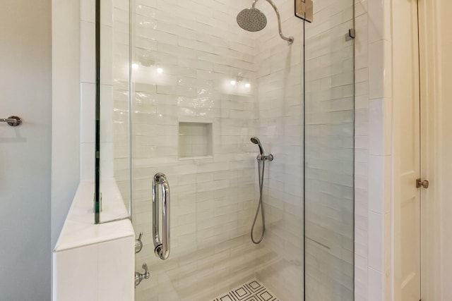 bathroom with a shower with shower door