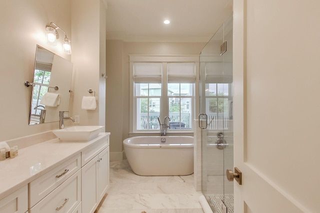 bathroom with vanity, shower with separate bathtub, and a healthy amount of sunlight