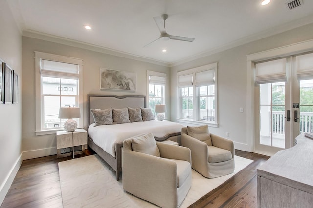 bedroom featuring hardwood / wood-style floors, multiple windows, access to exterior, and ornamental molding