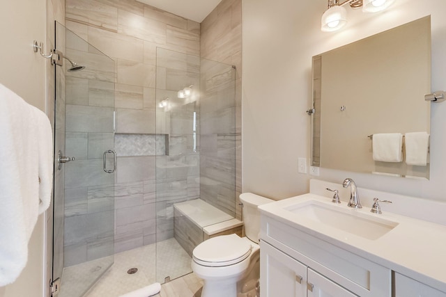 bathroom with toilet, vanity, and an enclosed shower