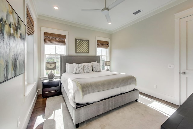 bedroom with hardwood / wood-style flooring, ceiling fan, and crown molding