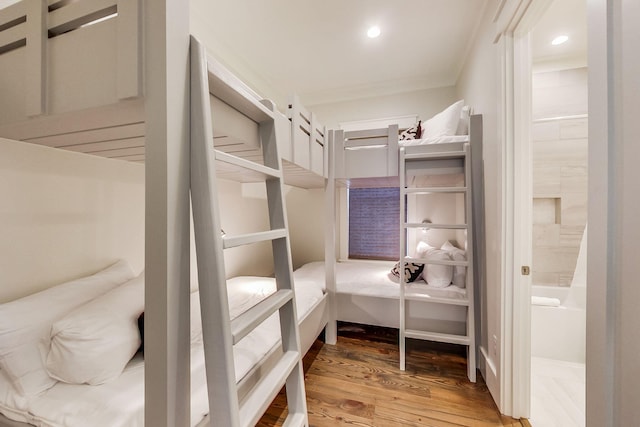 bedroom featuring ensuite bathroom and hardwood / wood-style floors