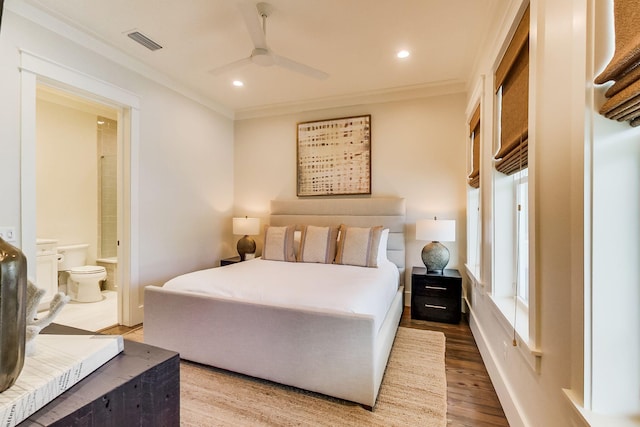 bedroom featuring ceiling fan, crown molding, connected bathroom, and hardwood / wood-style floors