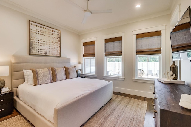 bedroom with ornamental molding, hardwood / wood-style flooring, and ceiling fan