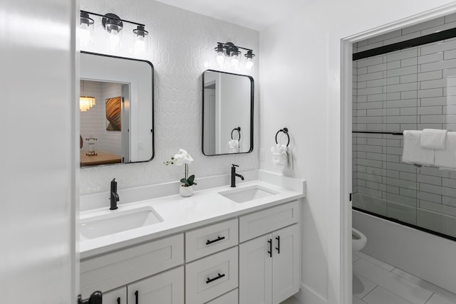 full bathroom with vanity, shower / bath combination with glass door, and toilet