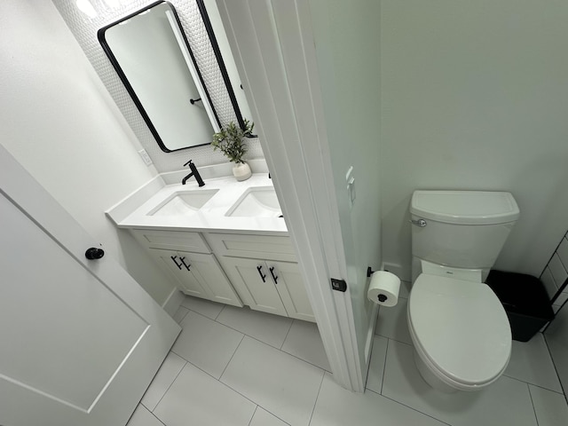 bathroom with vanity, tile patterned floors, and toilet