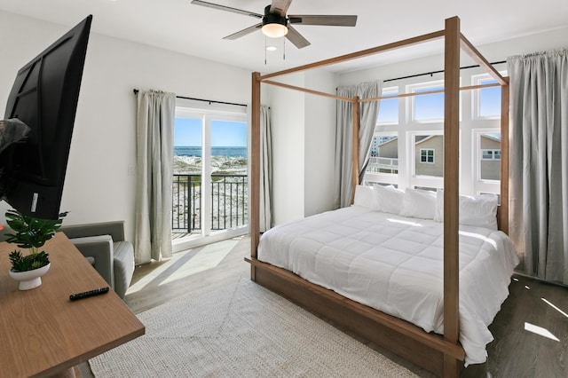 bedroom with access to exterior, hardwood / wood-style floors, and ceiling fan