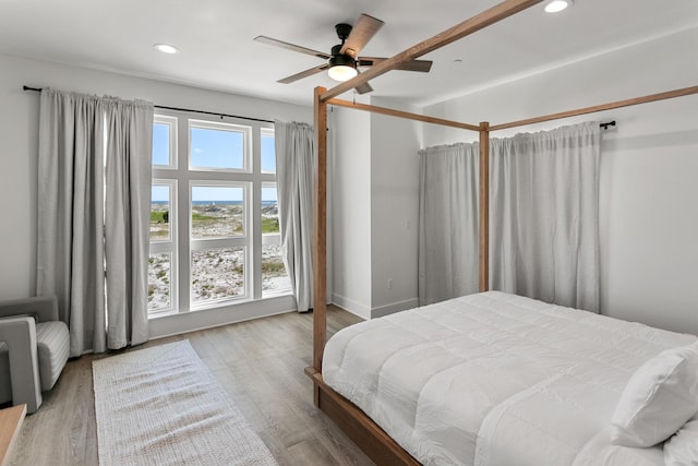 bedroom with ceiling fan and light hardwood / wood-style floors