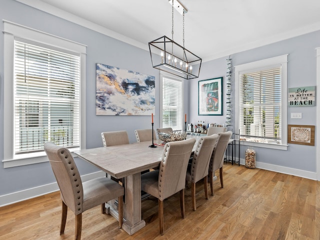 dining room featuring light hardwood / wood-style flooring, plenty of natural light, and an inviting chandelier