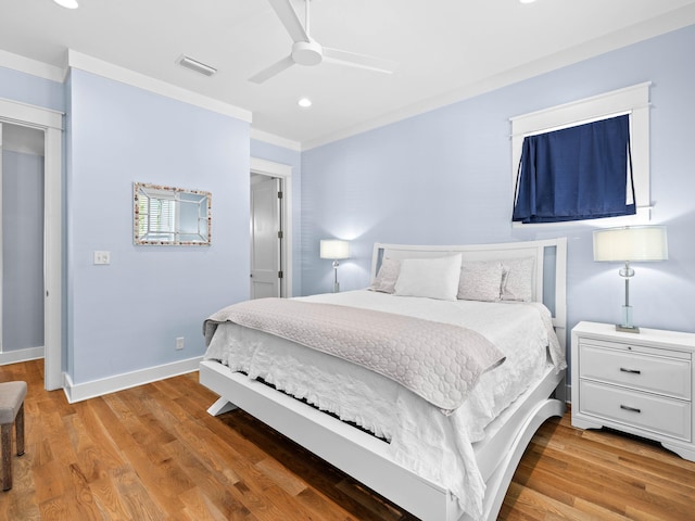 bedroom featuring ceiling fan, ornamental molding, and light hardwood / wood-style floors