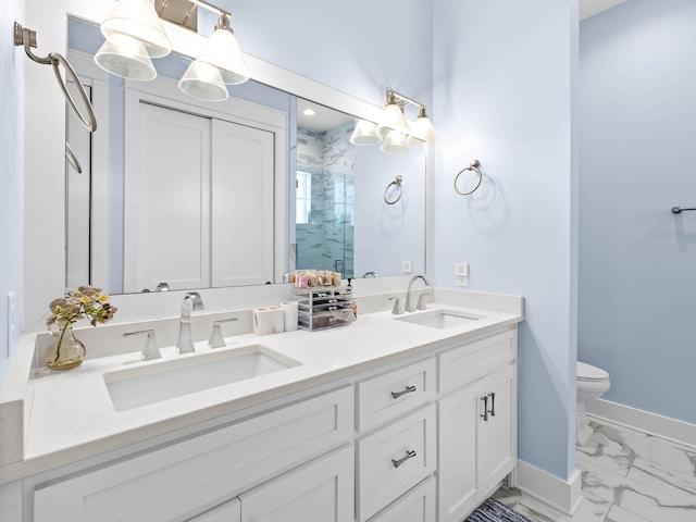 bathroom with vanity, a shower with door, and toilet