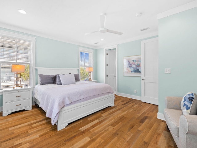 bedroom with ceiling fan and light hardwood / wood-style floors