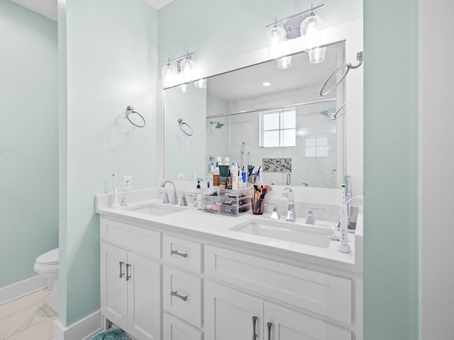 bathroom featuring an enclosed shower, vanity, and toilet