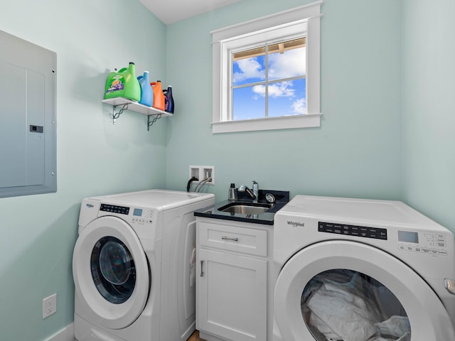 washroom featuring independent washer and dryer, electric panel, cabinets, and sink