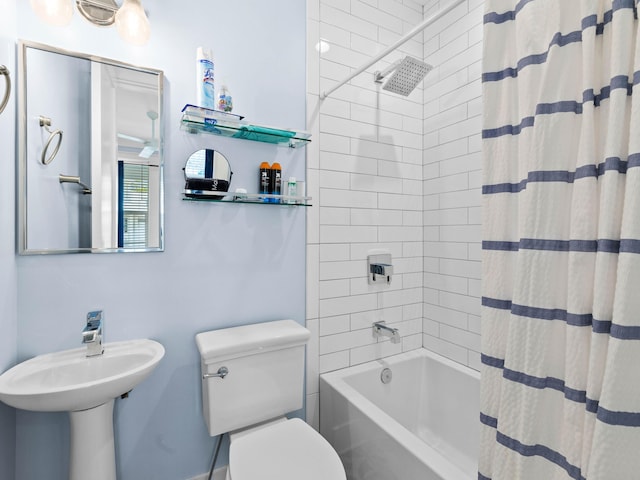 bathroom with shower / tub combo with curtain and toilet