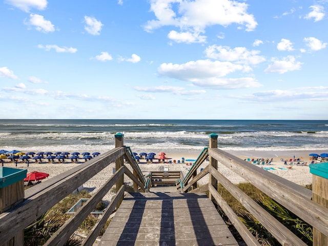 view of home's community with a water view and a view of the beach