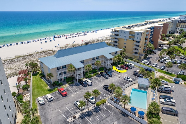 drone / aerial view featuring a water view and a beach view