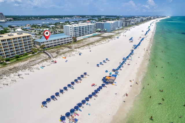 birds eye view of property with a view of the beach, a water view, and a city view